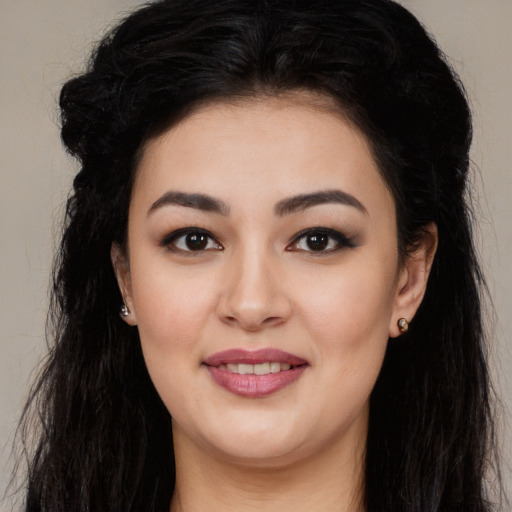 Joyful latino young-adult female with long  black hair and brown eyes