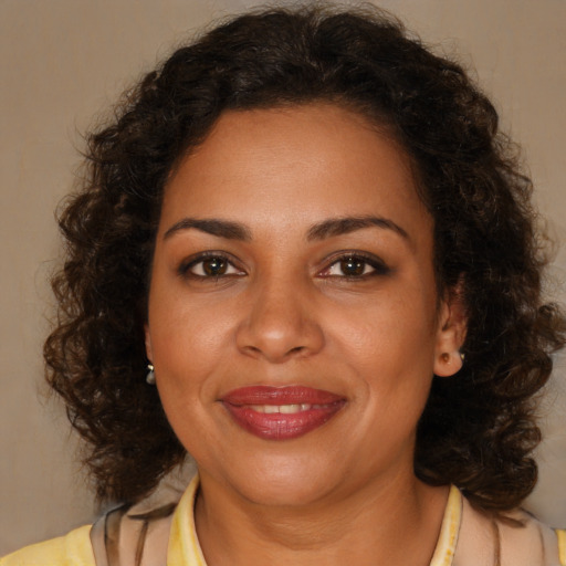 Joyful black young-adult female with medium  brown hair and brown eyes