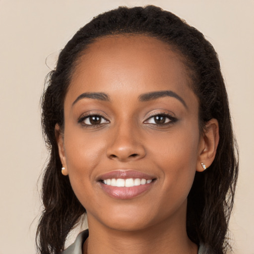 Joyful latino young-adult female with long  brown hair and brown eyes