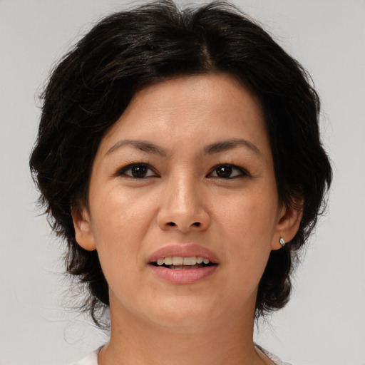 Joyful asian adult female with medium  brown hair and brown eyes