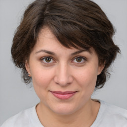 Joyful white adult female with medium  brown hair and brown eyes