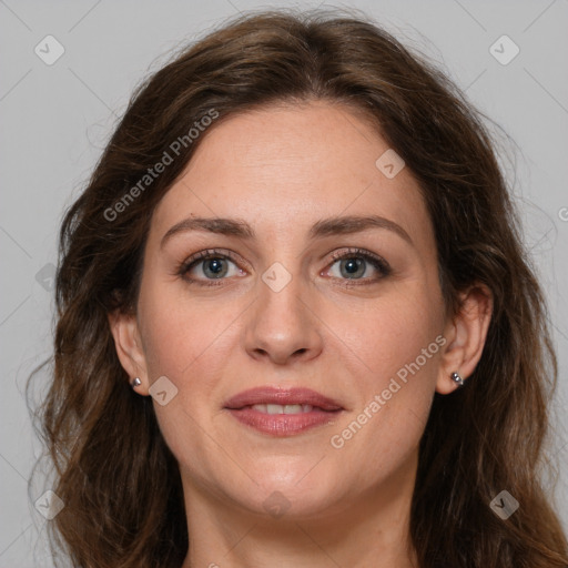 Joyful white adult female with long  brown hair and brown eyes