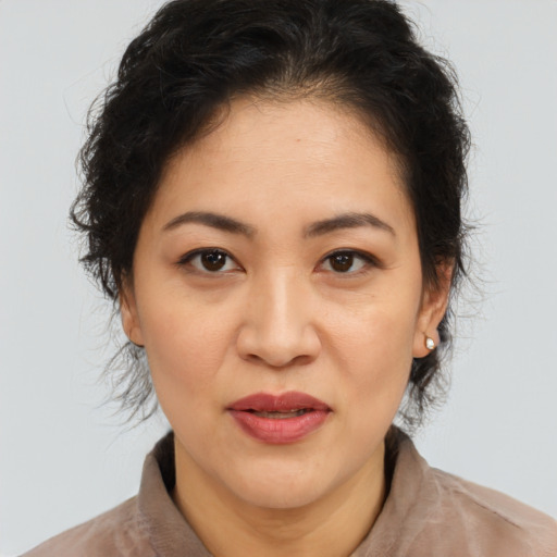 Joyful asian adult female with medium  brown hair and brown eyes
