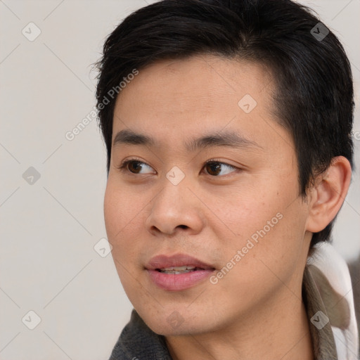 Joyful asian young-adult male with short  brown hair and brown eyes