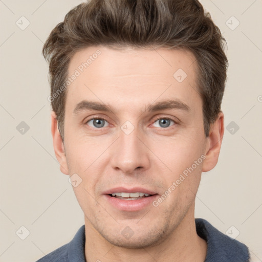 Joyful white adult male with short  brown hair and grey eyes