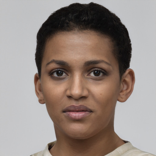 Joyful black young-adult female with short  brown hair and brown eyes