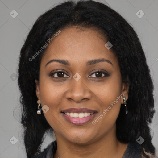 Joyful black young-adult female with long  brown hair and brown eyes