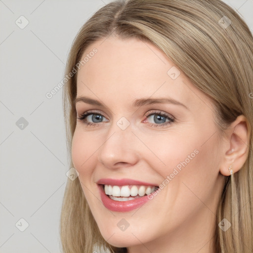 Joyful white young-adult female with long  brown hair and blue eyes