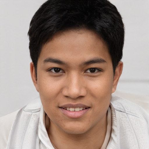 Joyful asian young-adult male with short  brown hair and brown eyes