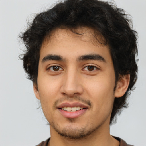 Joyful latino young-adult male with short  brown hair and brown eyes