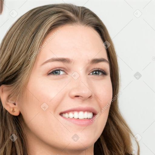 Joyful white young-adult female with long  brown hair and grey eyes