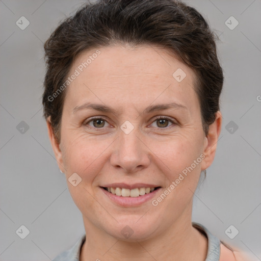 Joyful white adult female with short  brown hair and grey eyes