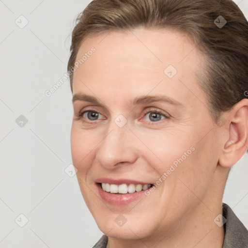 Joyful white adult female with short  brown hair and grey eyes