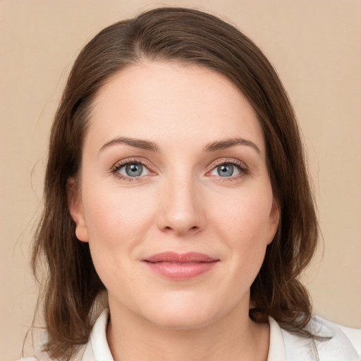 Joyful white young-adult female with medium  brown hair and green eyes