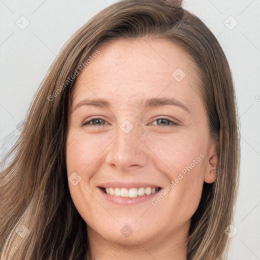 Joyful white young-adult female with long  brown hair and brown eyes