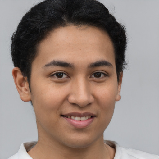 Joyful latino young-adult male with short  brown hair and brown eyes