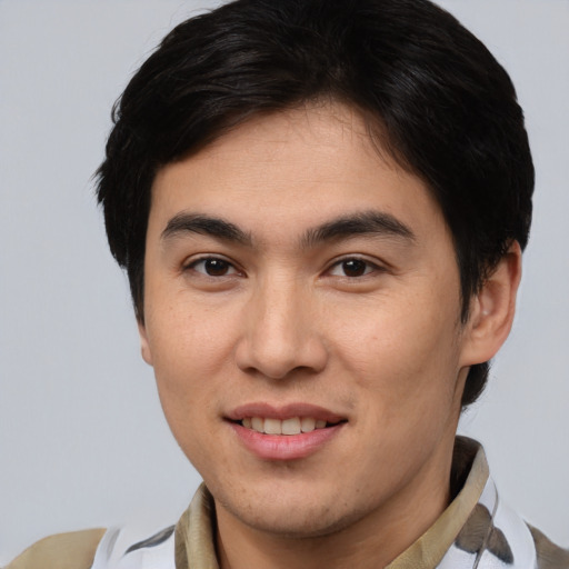 Joyful asian young-adult male with short  brown hair and brown eyes