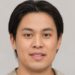 Joyful asian young-adult male with short  brown hair and brown eyes