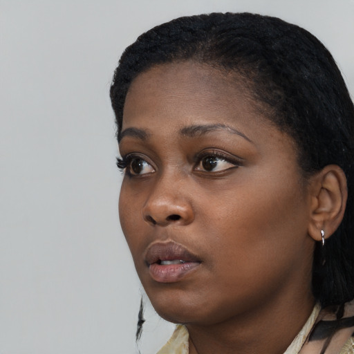 Neutral black young-adult female with medium  black hair and brown eyes