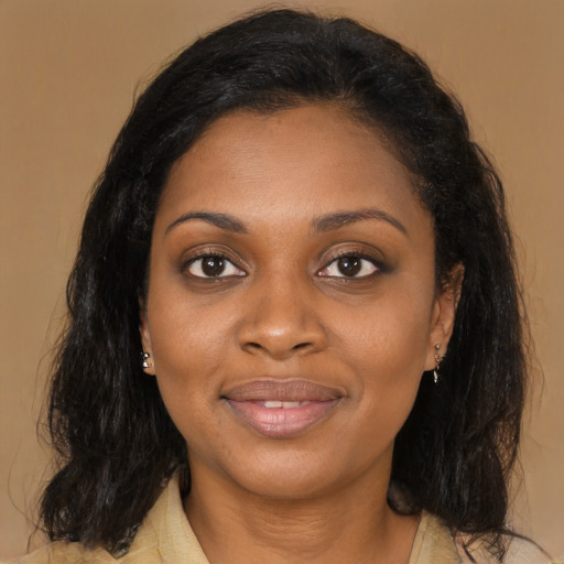 Joyful black young-adult female with long  brown hair and brown eyes