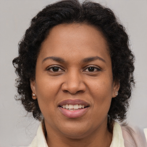 Joyful black young-adult female with medium  brown hair and brown eyes
