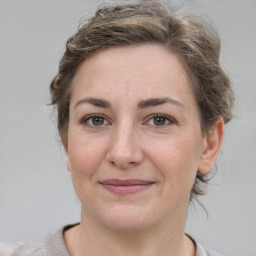 Joyful white adult female with medium  brown hair and brown eyes