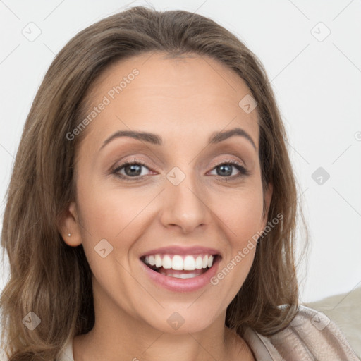 Joyful white young-adult female with long  brown hair and grey eyes