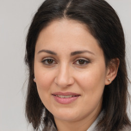 Joyful white adult female with long  brown hair and brown eyes