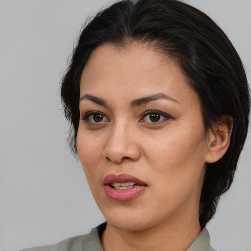 Joyful asian young-adult female with medium  brown hair and brown eyes
