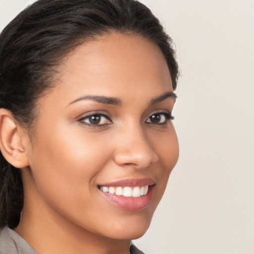 Joyful latino young-adult female with long  brown hair and brown eyes