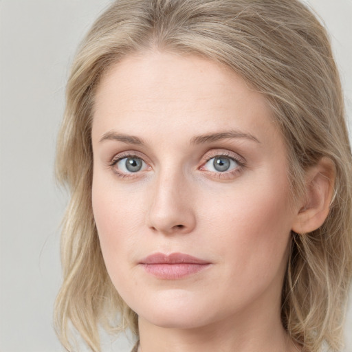 Joyful white young-adult female with long  brown hair and blue eyes