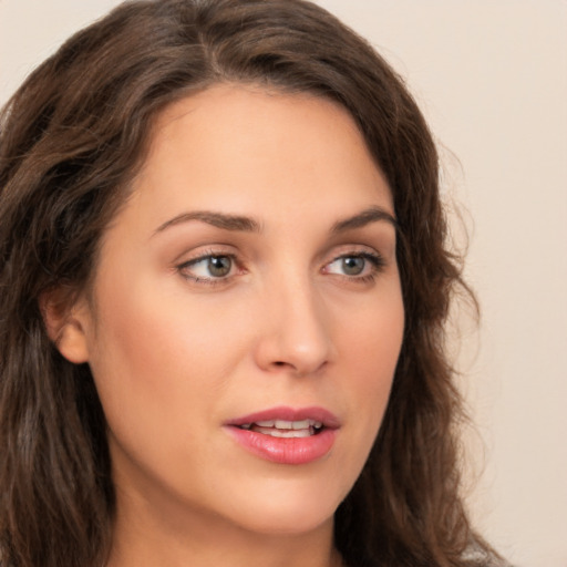 Joyful white young-adult female with long  brown hair and green eyes