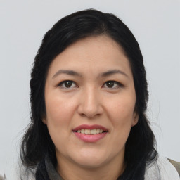 Joyful asian adult female with medium  brown hair and brown eyes