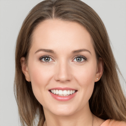 Joyful white young-adult female with long  brown hair and grey eyes