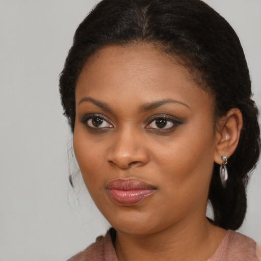 Joyful black young-adult female with medium  brown hair and brown eyes