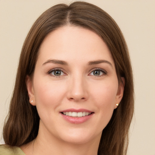 Joyful white young-adult female with long  brown hair and green eyes