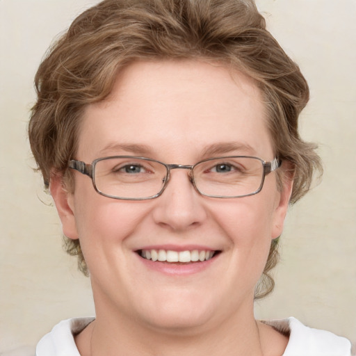 Joyful white adult female with medium  brown hair and blue eyes