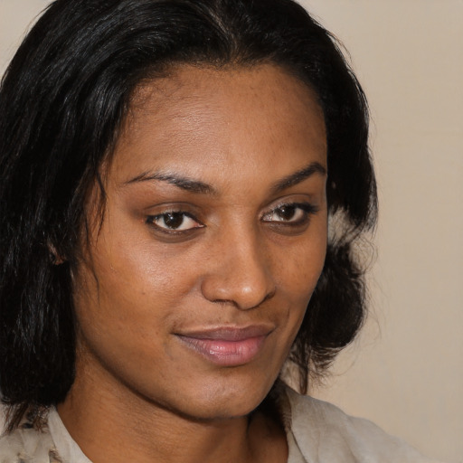 Joyful black young-adult female with medium  brown hair and brown eyes