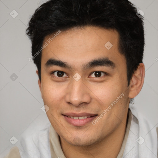 Joyful latino young-adult male with short  brown hair and brown eyes