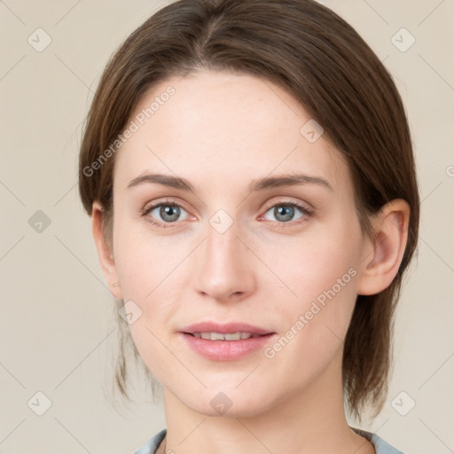 Joyful white young-adult female with medium  brown hair and green eyes