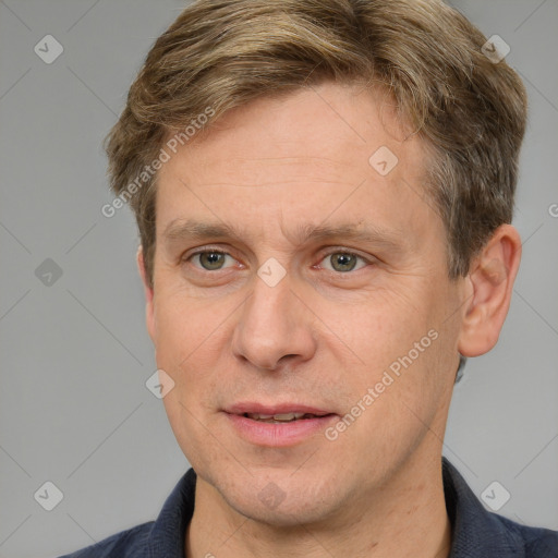 Joyful white adult male with short  brown hair and grey eyes