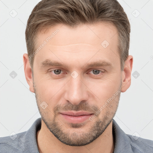 Joyful white young-adult male with short  brown hair and grey eyes