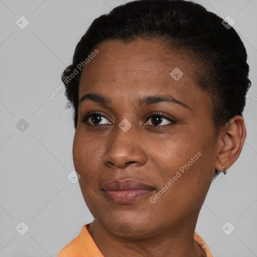 Joyful black young-adult female with short  brown hair and brown eyes