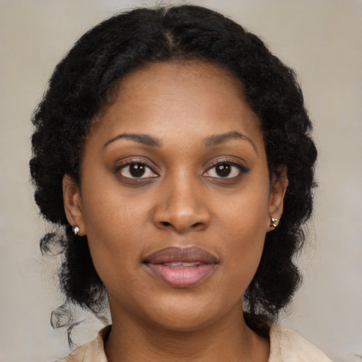 Joyful black young-adult female with medium  brown hair and brown eyes