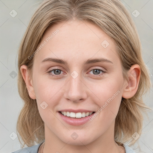 Joyful white young-adult female with medium  brown hair and blue eyes