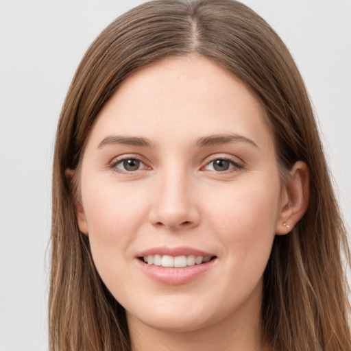 Joyful white young-adult female with long  brown hair and grey eyes