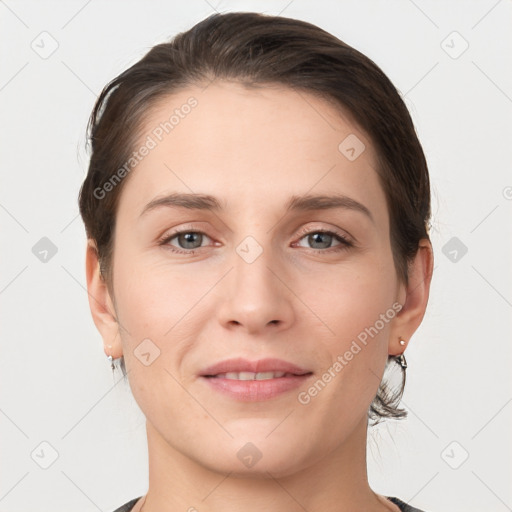 Joyful white young-adult female with short  brown hair and grey eyes