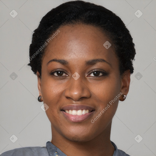 Joyful black young-adult female with short  black hair and brown eyes