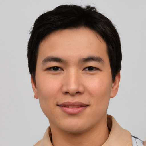 Joyful asian young-adult male with short  black hair and brown eyes