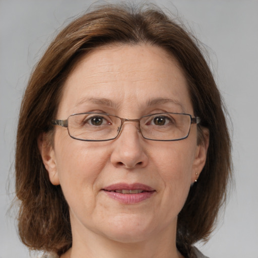 Joyful white middle-aged female with medium  brown hair and brown eyes